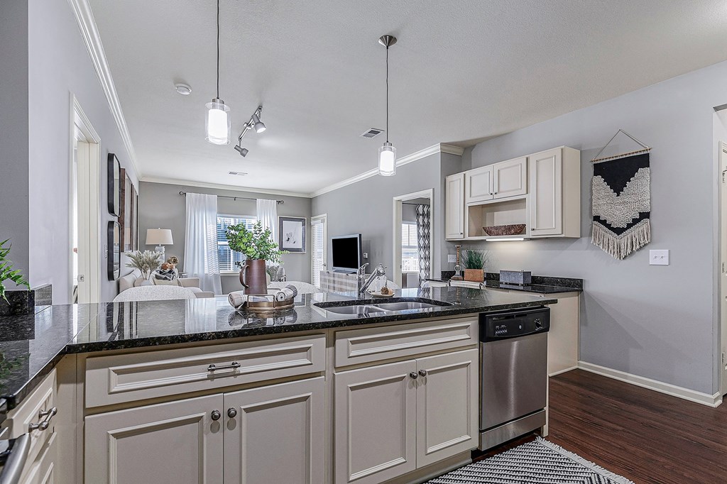 an open kitchen and living room with a large counter top