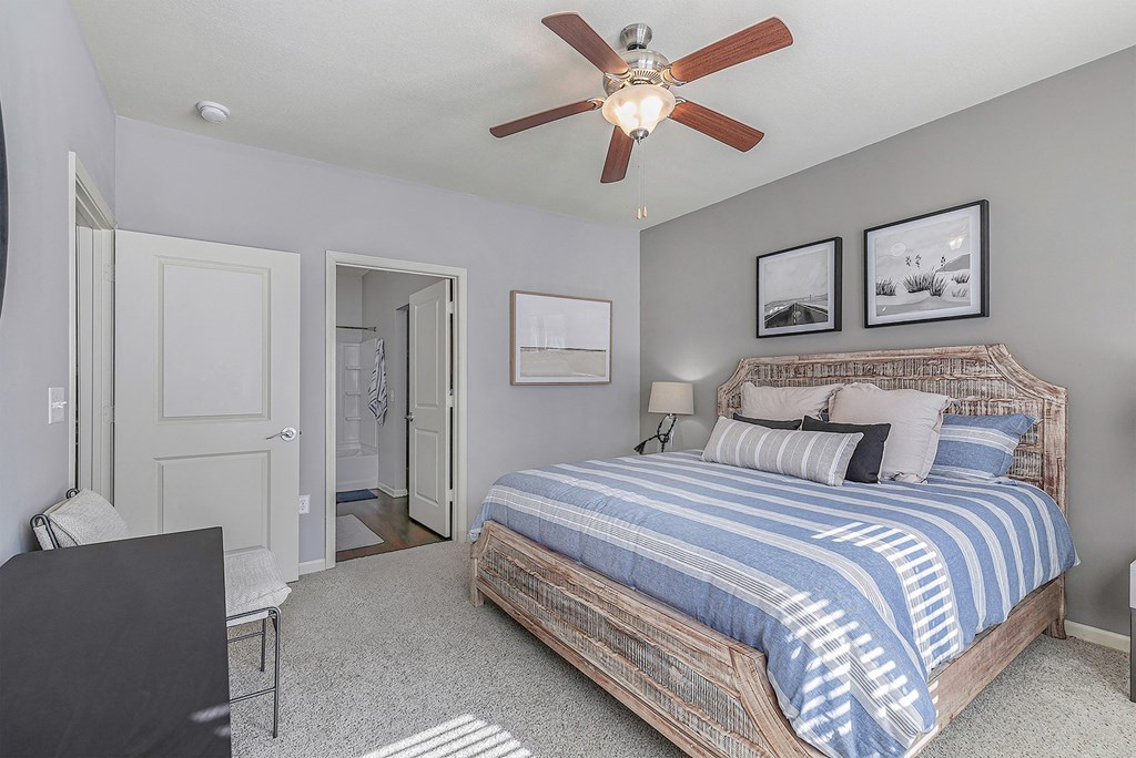 a bedroom with a bed and a ceiling fan