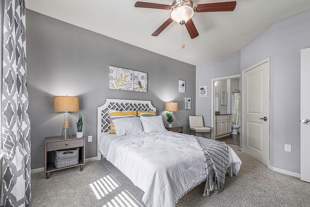 a bedroom with a bed and a ceiling fan