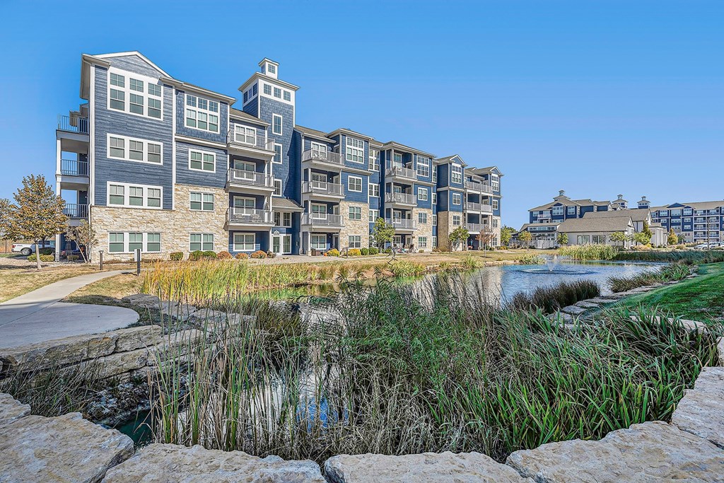 an apartment building overlooks a small body of water