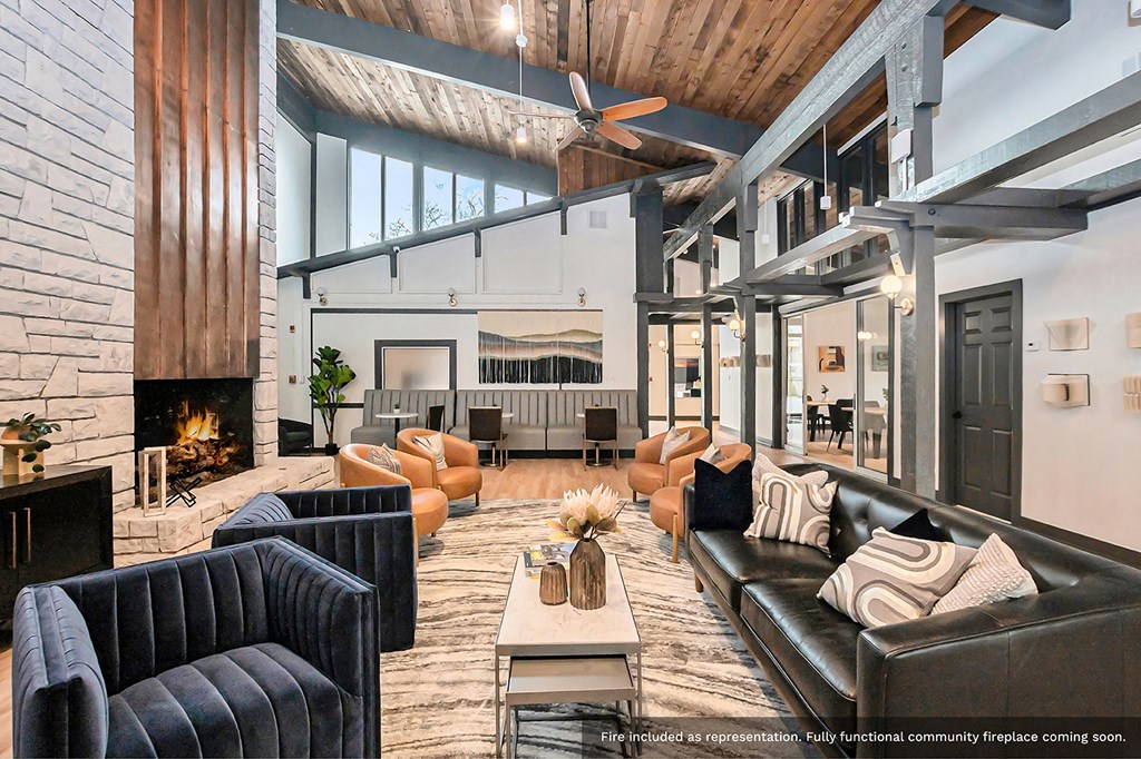 a large living room with leather furniture and a fireplace