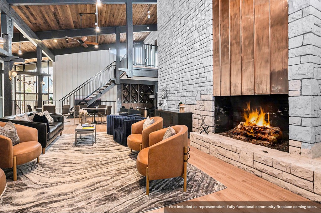 a living room with a fireplace and chairs