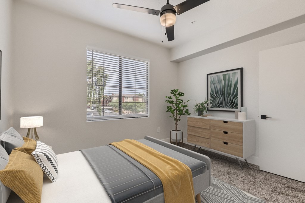 a bedroom with a bed and a ceiling fan
