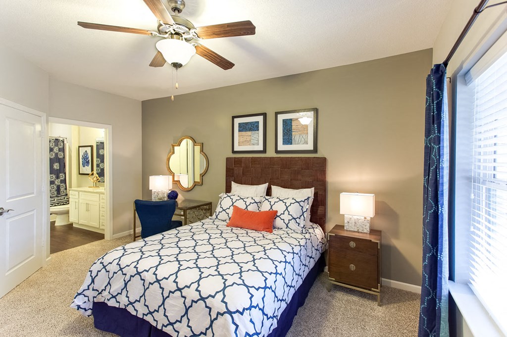 a bedroom with a bed and a ceiling fan