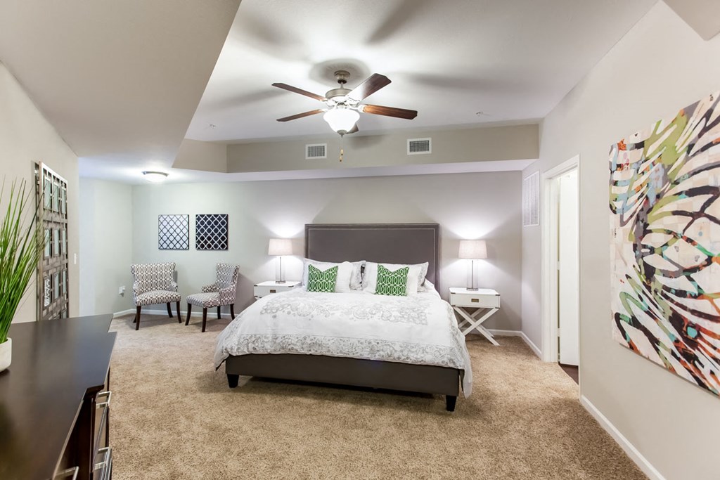 a bedroom with a large bed and a ceiling fan