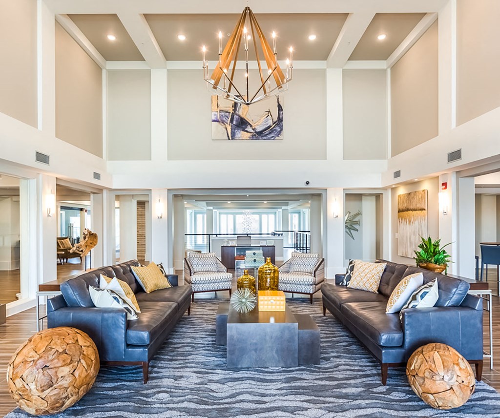 a living room with couches and chairs and a chandelier