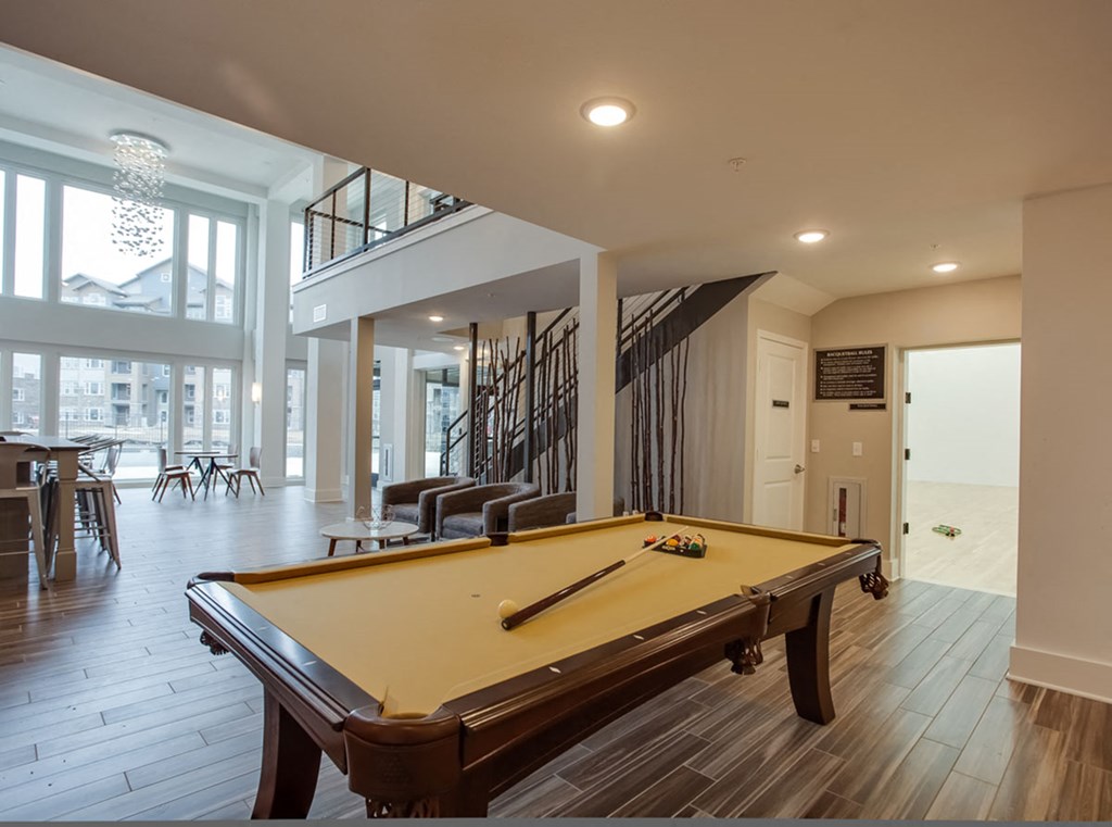 a pool table in the clubhouse at the flats at obsidian