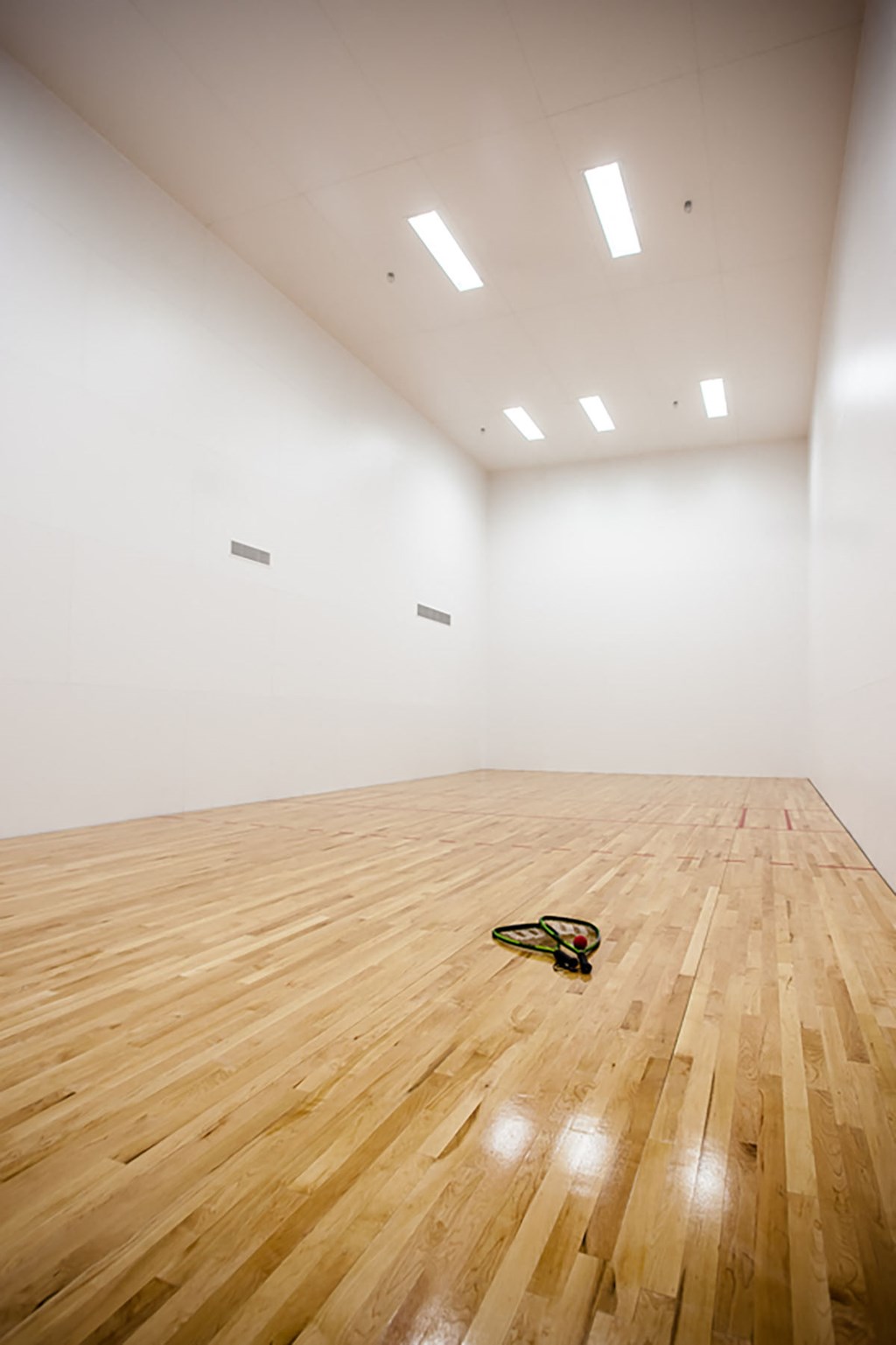 a guitar laying on the floor of an empty room
