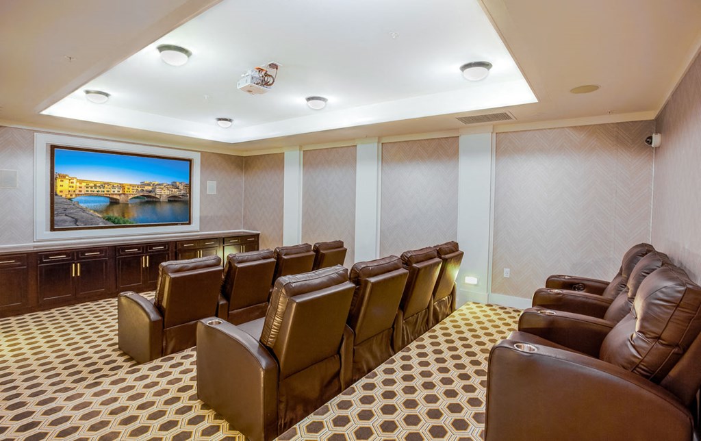 a conference room with leather chairs and a television