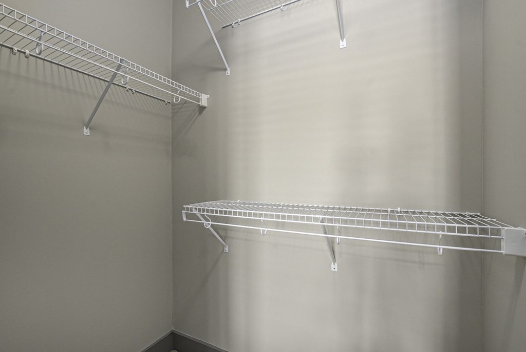 a walk in closet in a bedroom plus den unit at the casey, 2100 delgan