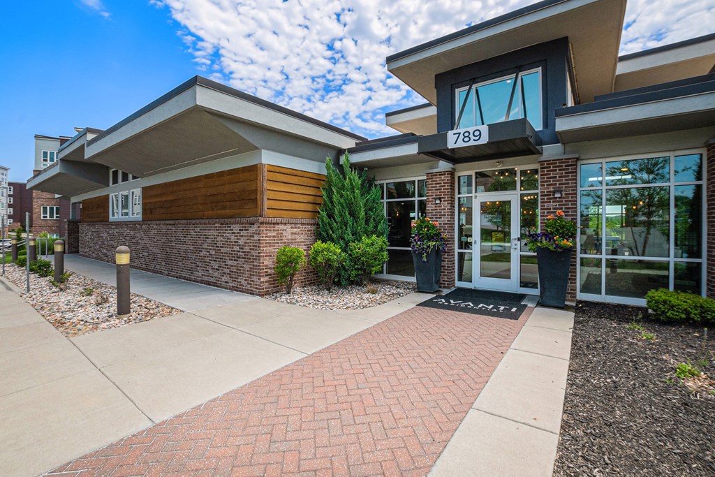 a picture of the front of a building with a blue sky in the background