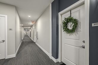 a photo of a corridor in an office building with a wreath on the door
