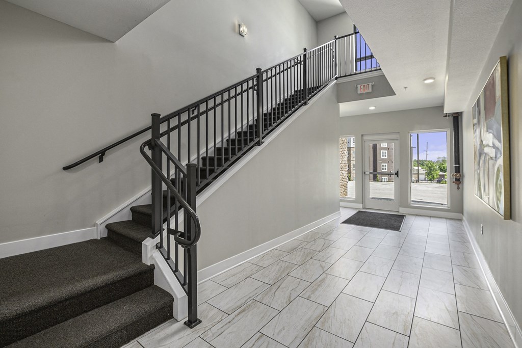 a look at the entryway of a house with a staircase and a glass door