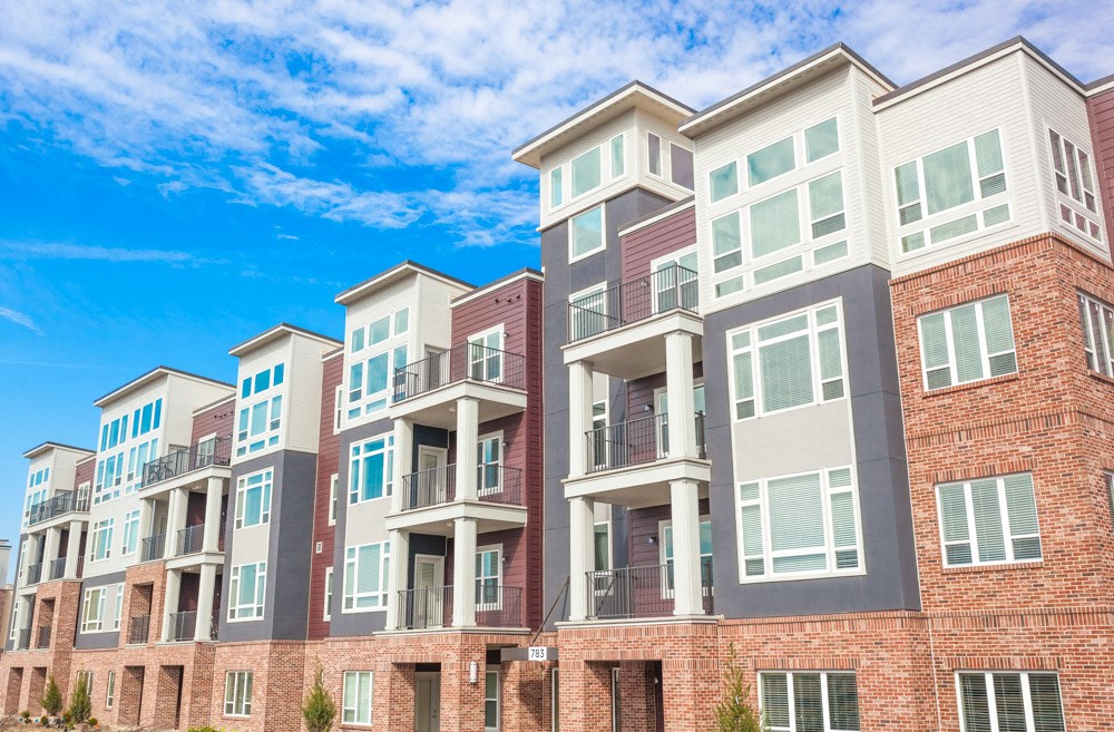 a row of apartment buildings on a sunny day