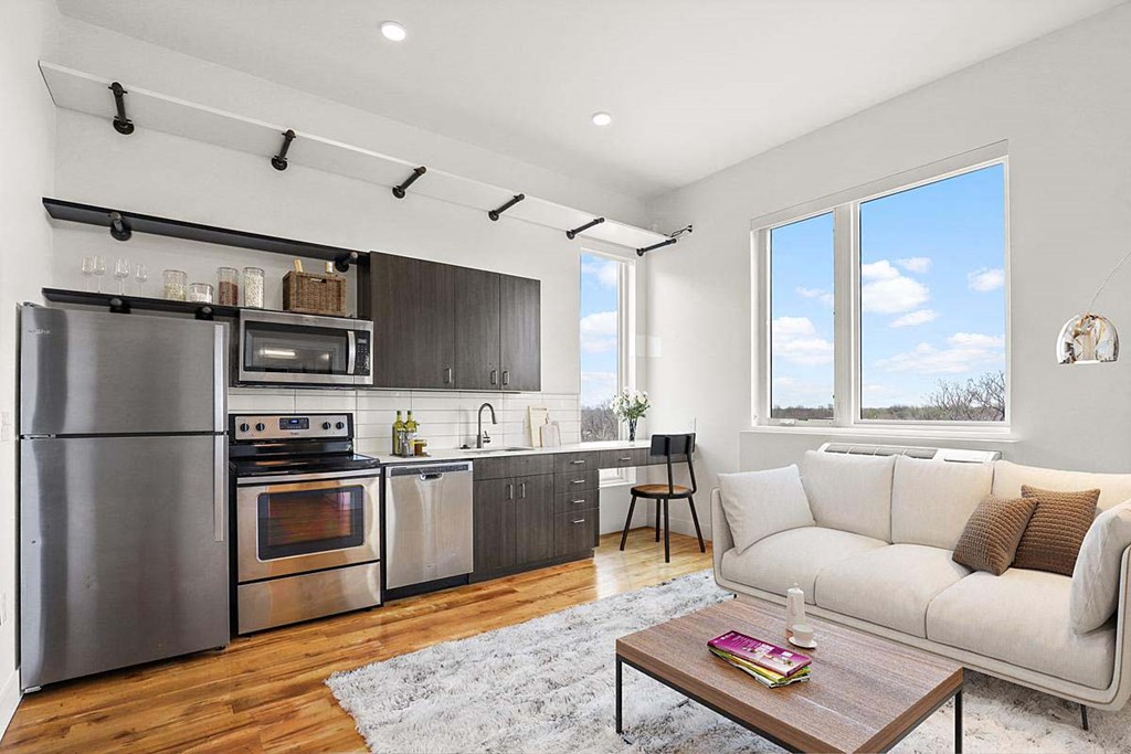 an open kitchen and living room with a couch