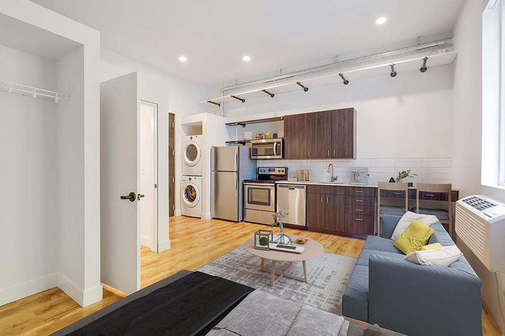 a living room with a couch and a kitchen