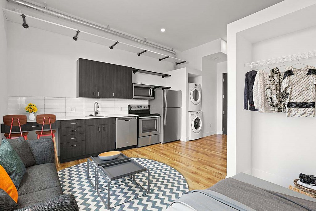 a living room with a couch and a kitchen