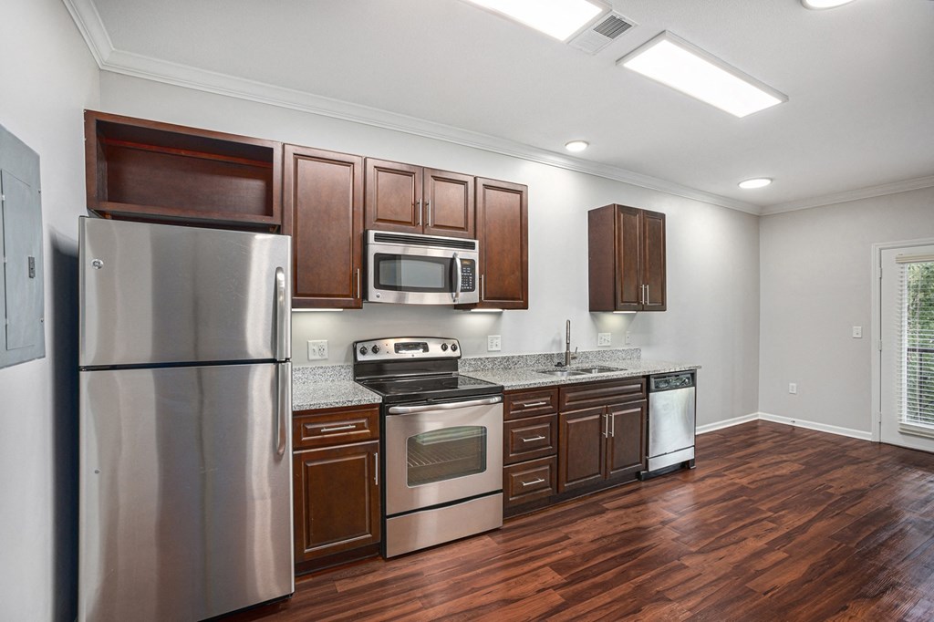 a kitchen with wooden cabinets and stainless steel appliances