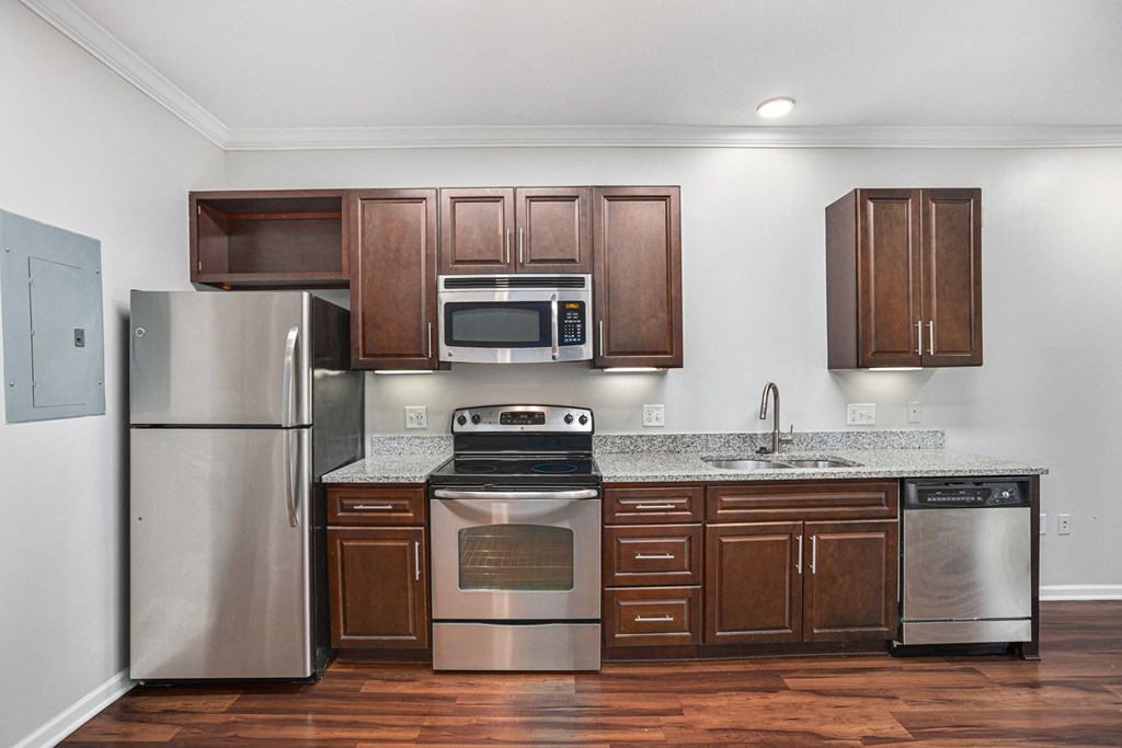 a kitchen with wooden cabinets and stainless steel appliances
