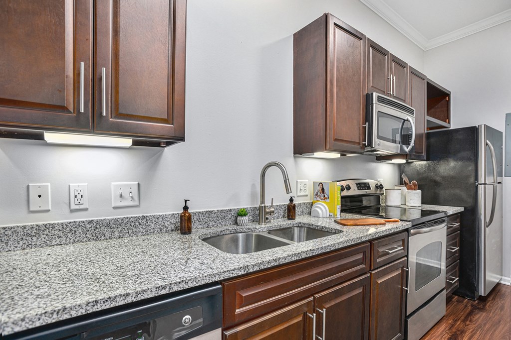 a kitchen with wood cabinets and granite countertops