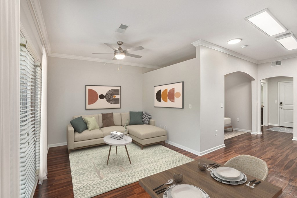 a living room with a ceiling fan and hardwood floors