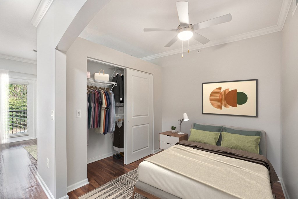 a bedroom with a bed and a ceiling fan