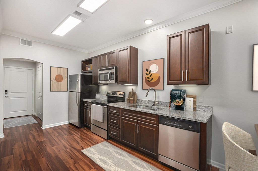 a kitchen with dark wood cabinets and granite countertops