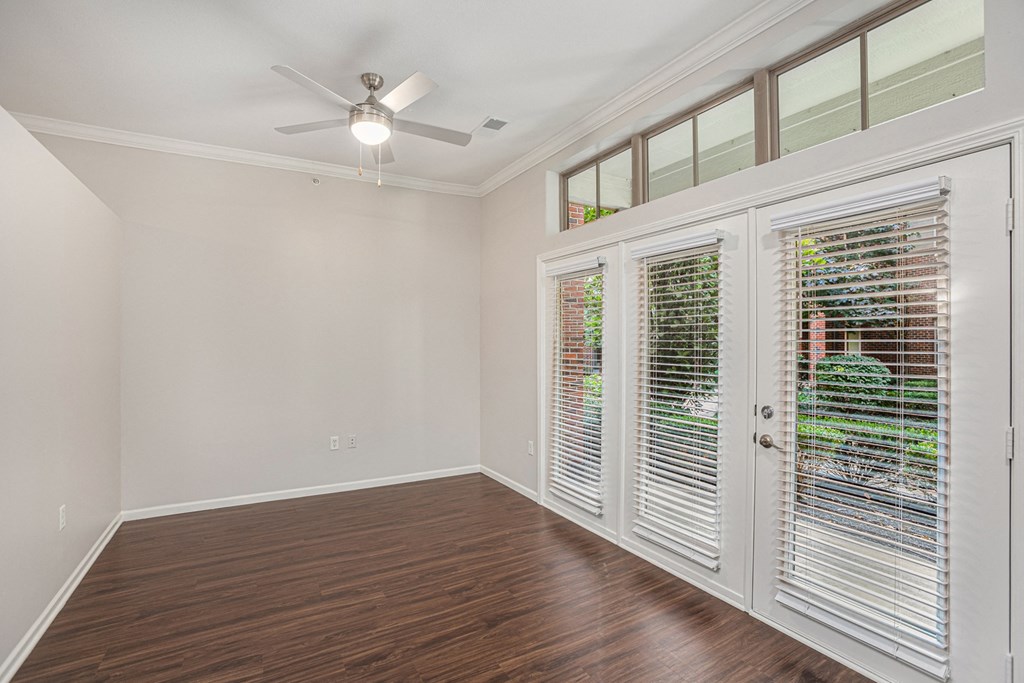 a bedroom with hardwood floors and a ceiling fan
