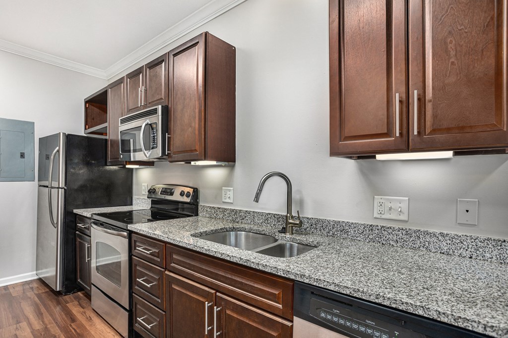 a kitchen with wood cabinets and granite countertops