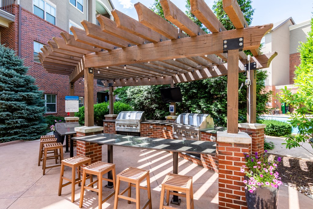 a patio with a bar and a pergola