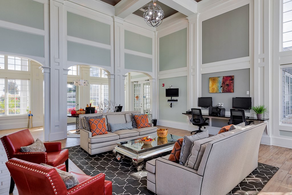 a living room with couches and chairs and a tv