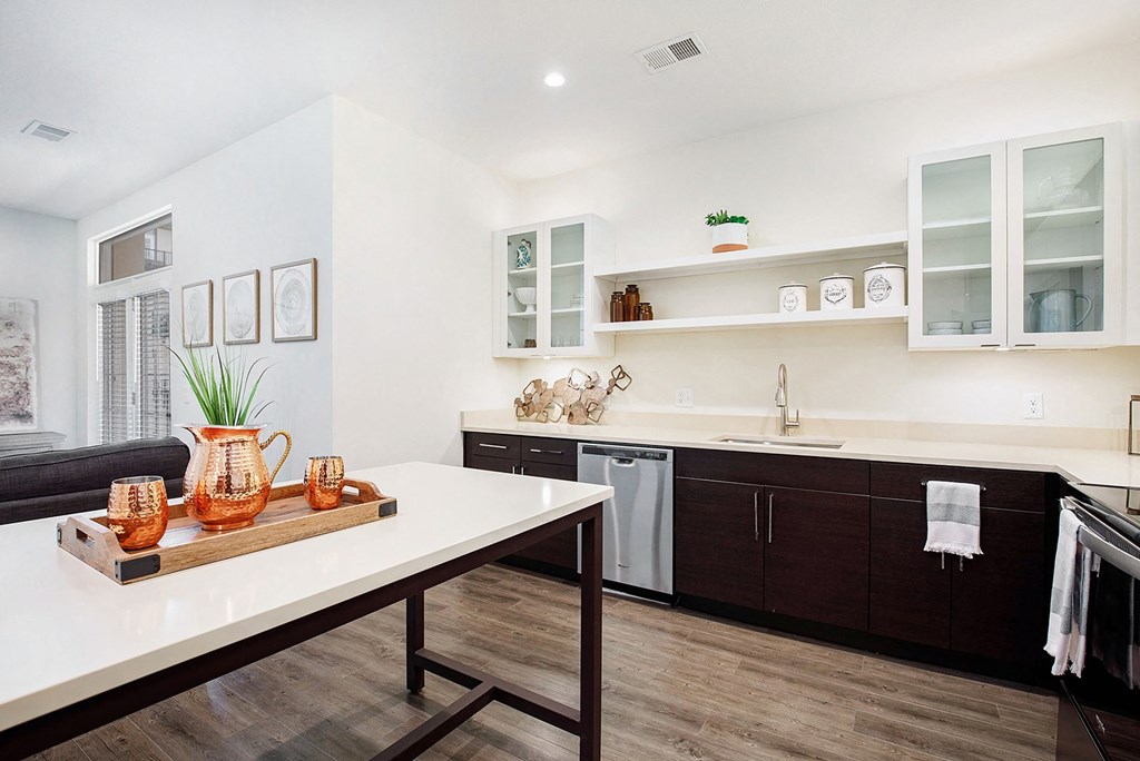 a kitchen with a white counter top and a table