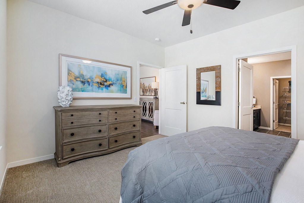 a bedroom with a bed and a ceiling fan