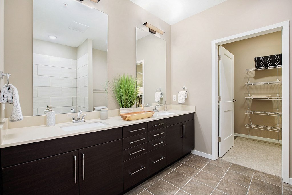 a bathroom with two sinks and a mirror