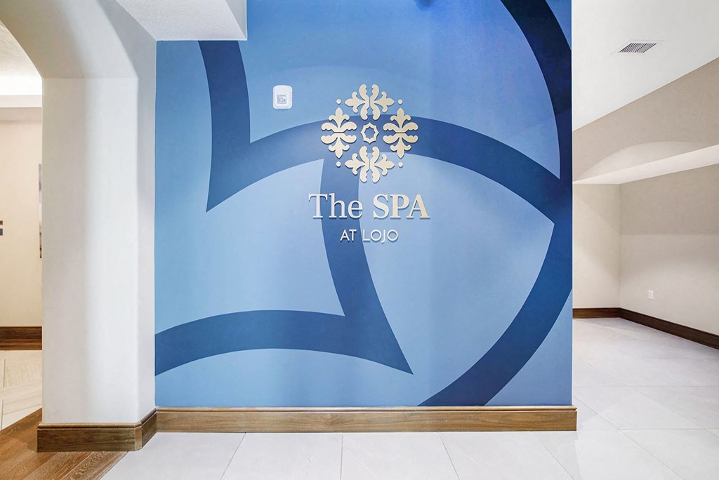 a blue wall with the spa logo on it in a lobby