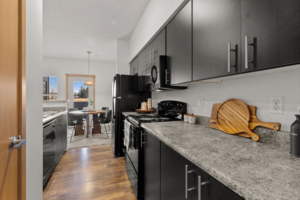 Kitchen with wooden closet at Tustin Apartment Homes, Yelm, WA, Washington , 98597