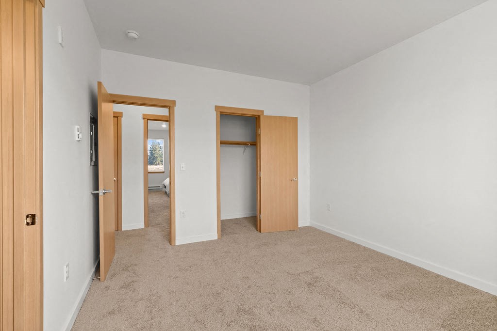 Bedroom With Closet at Tustin Apartment Homes, Yelm