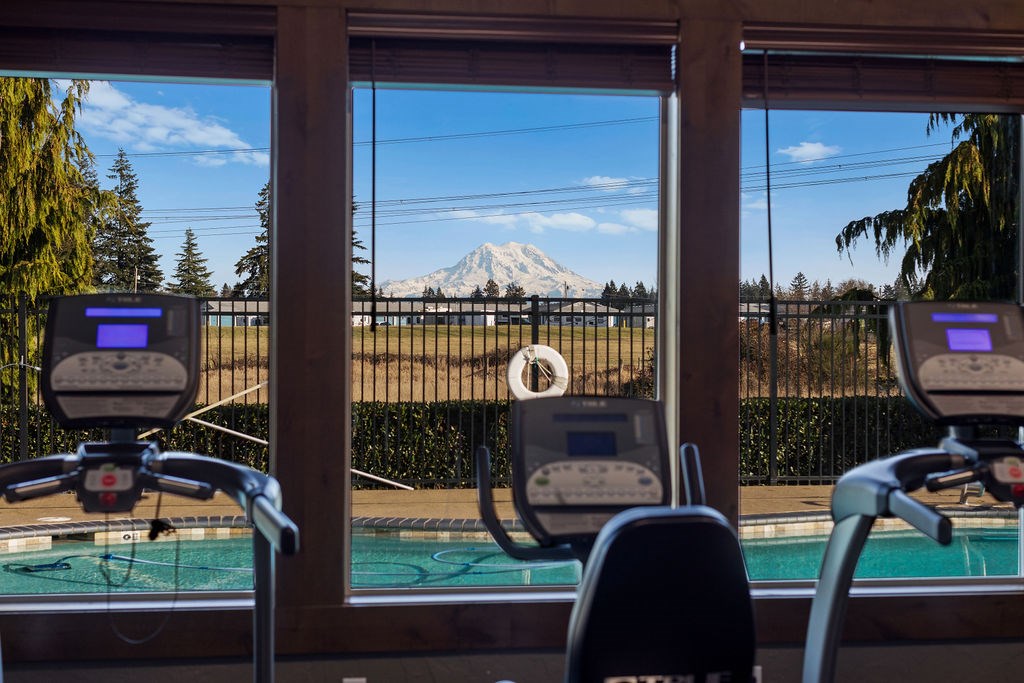 Fitness Center With Outside View at Tustin Apartment Homes, Yelm