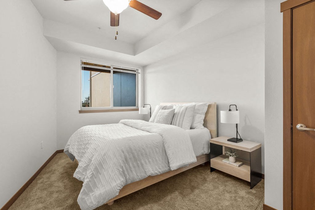 a bedroom with a bed and a window