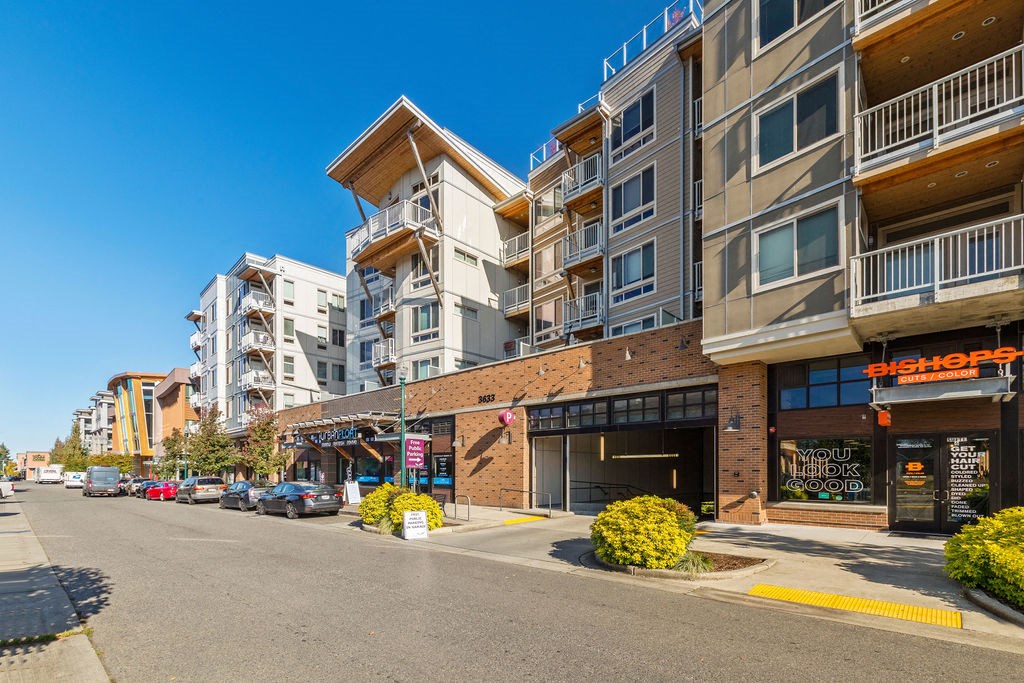 an empty street in front of an apartment building