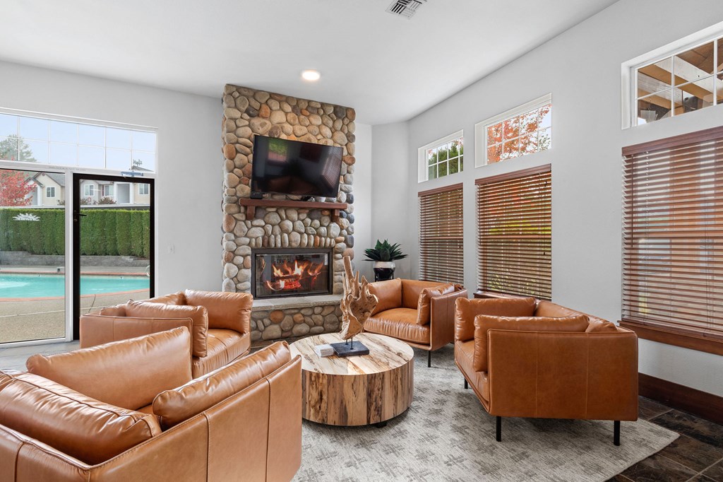 Pet-Friendly Apartments in Milton - Sundance - Club Room with Pebbled Fireplace, Acces to Pool, and Leather Seating Area