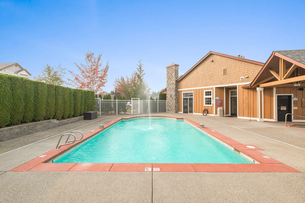 Dog-Friendly Apartments in Milton - Sundance - Pool with Tall Trimmed Bushes, Jacuzzi, and a Waterfall