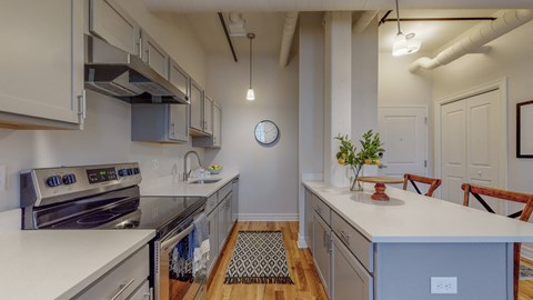 a kitchen with white counters and stainless steel appliances