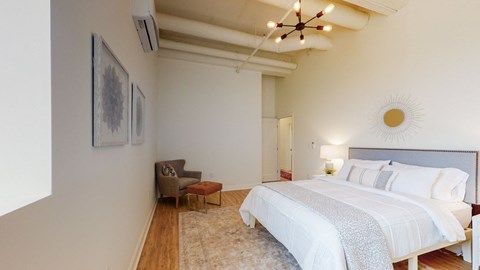 a bedroom with a large bed and a ceiling fan