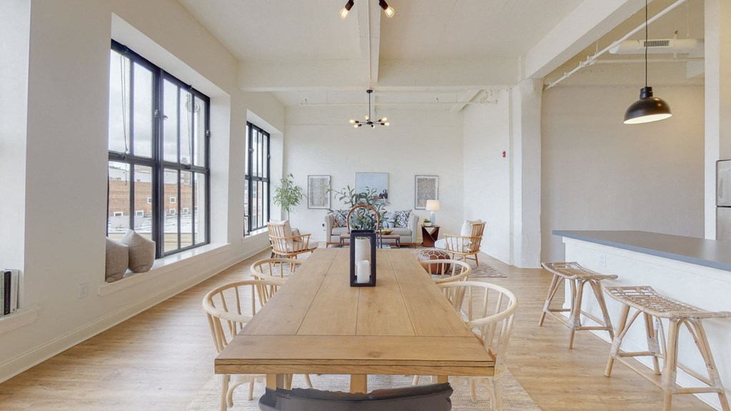 a dining room with wooden tables and chairs and a large window