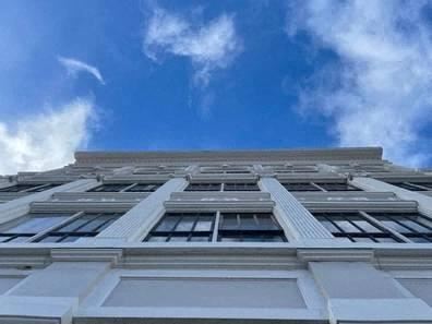 a tall white building with the sky in the background