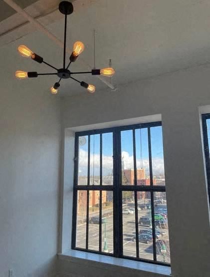a ceiling fan with lights and a window