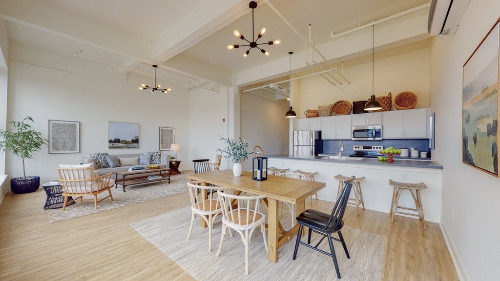 a living room with a dining room table and a kitchen