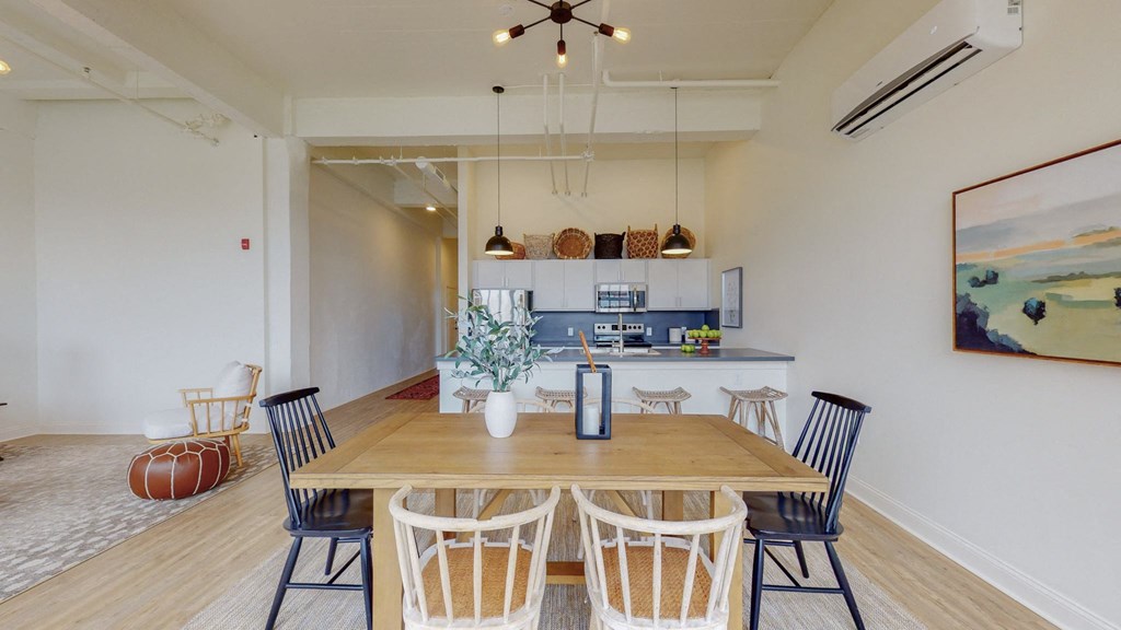 a dining room with a table and chairs and a kitchen