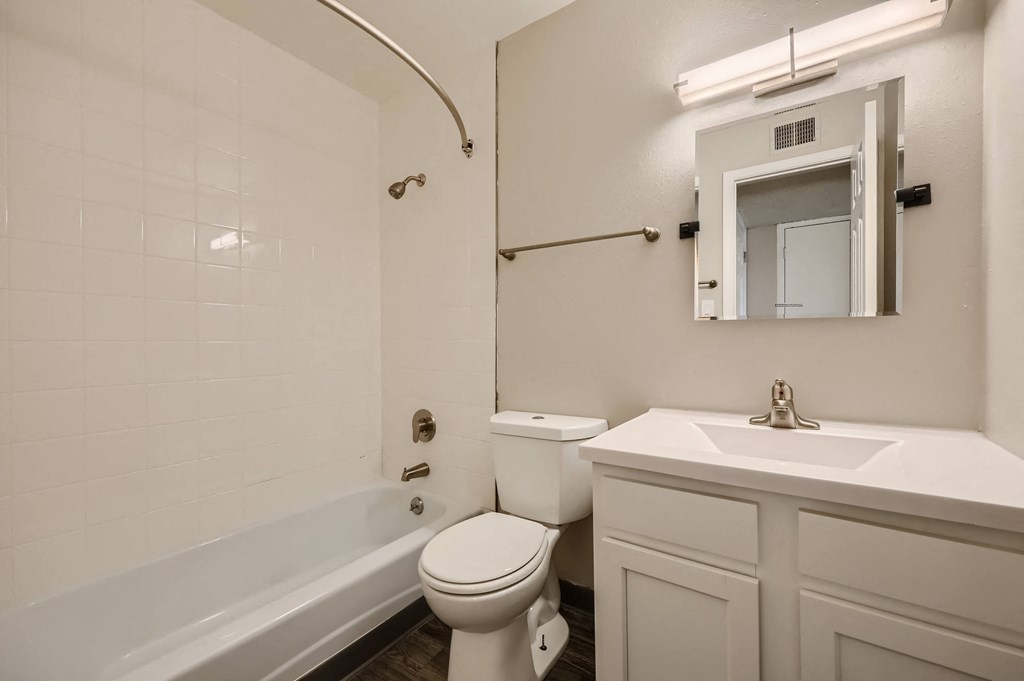 a bathroom with a sink toilet and a tub